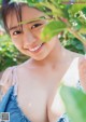 A young woman in a blue dress posing for a picture.